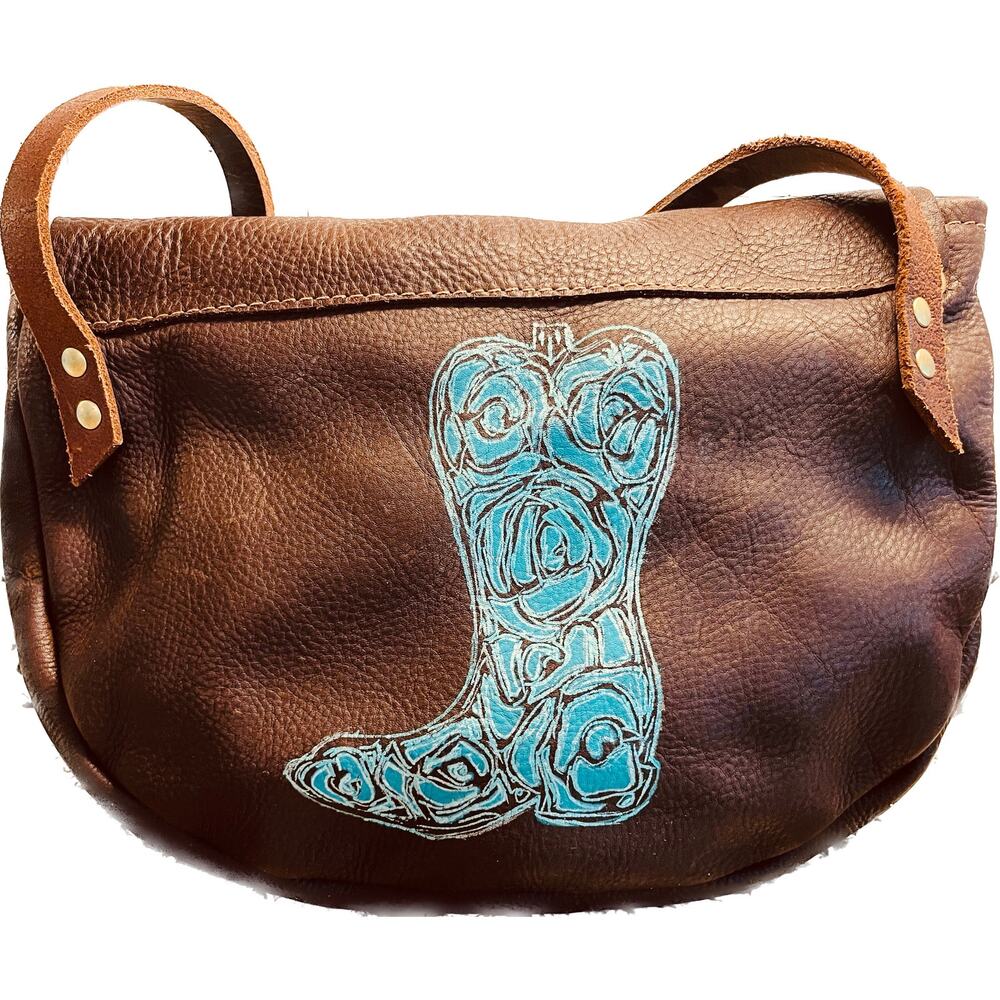 Leather crossbody handbag with painted floral cowboy boot in teal and silver.